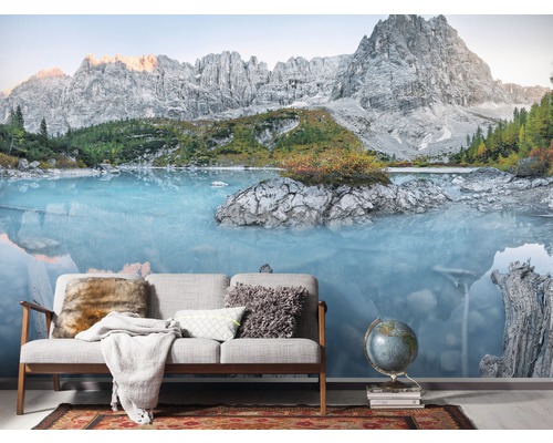 Fototapete mit Bergsee-Motiv hinter Sofa und Globus