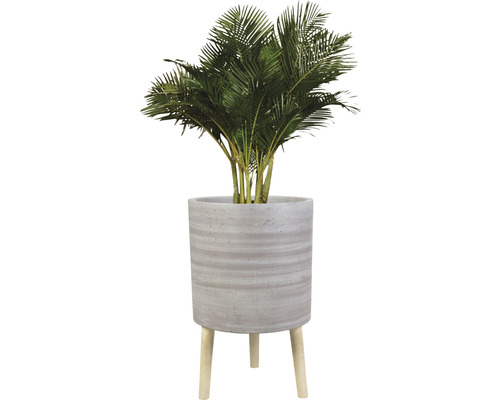 Künstliche Palme in einem Topf mit Holzbeinen