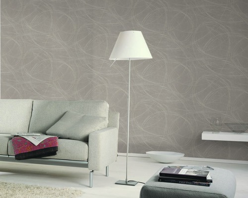 Wohnzimmer mit grauer Designertapete, Stehlampe, Sofa und Hocker