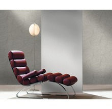 Raumansicht mit Sessel, Stehlampe und gemusterter Tapete