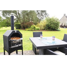 Pizzaofen und Gartentisch mit Stühlen auf einer Terrasse