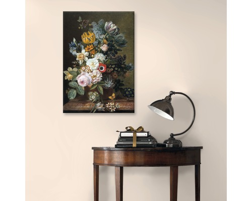 Gemälde mit Blumenstillleben über Büchern und einer Lampe auf einem Tisch