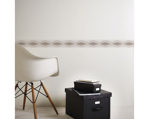 Zimmer Szene mit dekorativer Bordüre an der Wand, einem Stuhl und Aufbewahrungsboxen