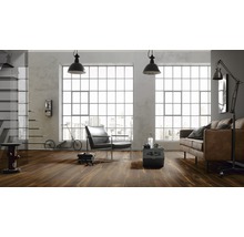Wohnzimmer im Loft Stil mit Holzboden, Sessel, Sofa und großen Fenstern