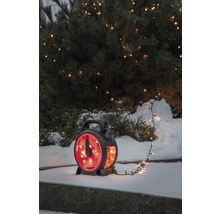 Lichterkette mit Aufroller vor einem schneebedeckten Busch