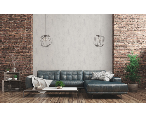 Wohnzimmer mit Ziegelwand, Sofa, Couchtisch und Pendelleuchten
