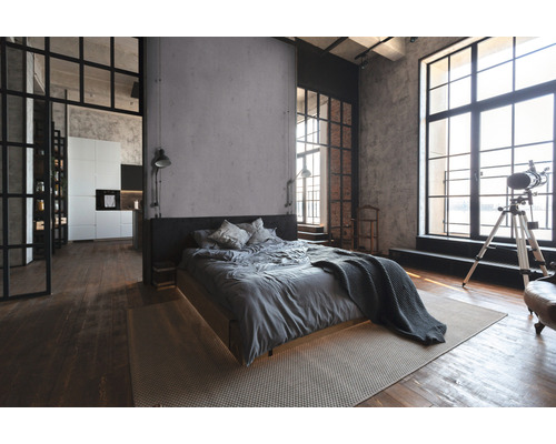 Schlafzimmer im Loftstil mit Bett, Teppich und großen Fenstern