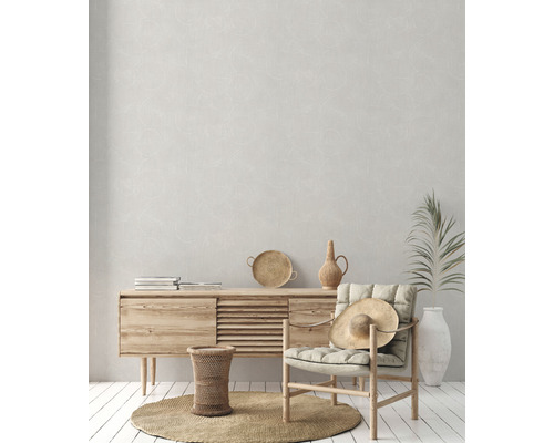 Heller Raum mit Holzkommode, Stuhl mit Hut, rundem Teppich und Dekorationen für ein gemütliches Ambiente