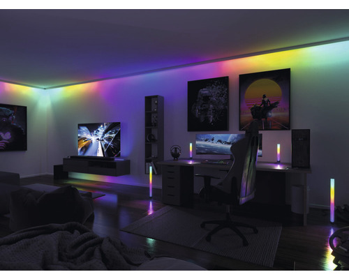 Einrichtung eines Spielzimmers mit Schreibtisch, Gaming-Stuhl, Fernseher und mehrfarbiger Beleuchtung