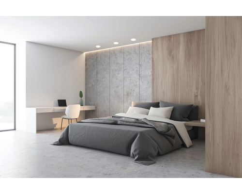 Helles Schlafzimmer mit Doppelbett, Schreibtisch und Betonwand