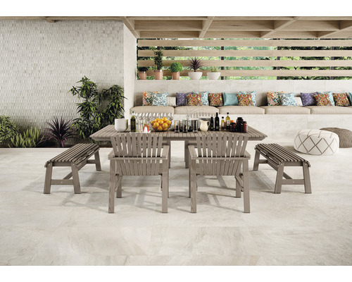 Terrasse mit Fliesenboden, Gartentisch, Stühlen und Bänken