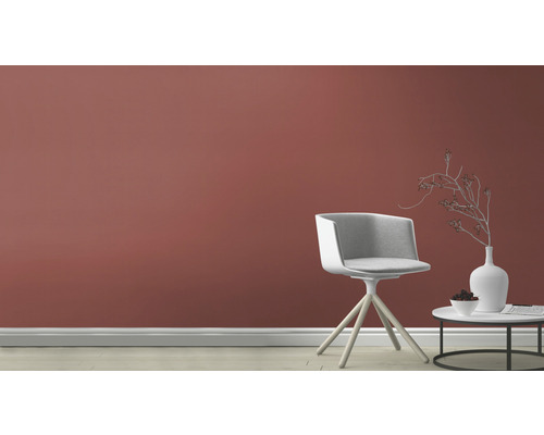 Heller Raum mit Stuhl und Beistelltisch vor einer Wand