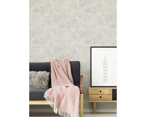 Szene mit Couch, Decke, Kissen und gemusterter Tapete für Wohnraumgestaltung