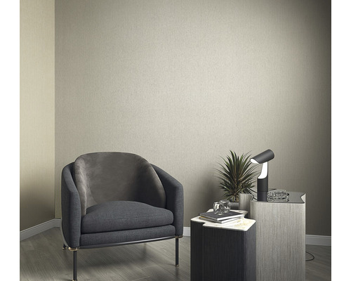 Einrichtungsidee mit Sessel, Tisch und Lampe vor einer einfarbigen Wand