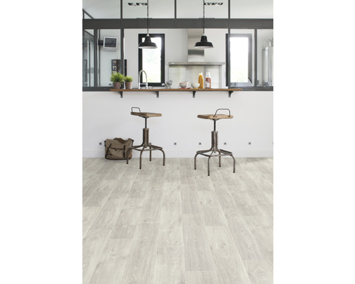 Helle Küche mit Holzboden und Barhockern.