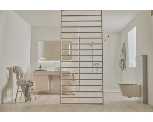 Badezimmer mit Waschtisch, Spiegel, Toilette und Raumteiler