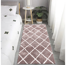 Schlafzimmer mit Bett, Beistelltisch, Topfpflanze und Teppich mit Rautenmuster