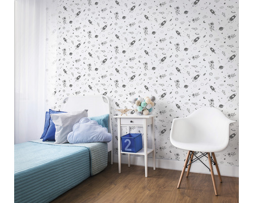Dekoriertes Kinderzimmer mit Weltraumtapete, Bett, Nachttisch und Stuhl