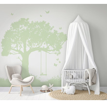 Kinderzimmer mit Baum Wandtattoo, Stuhl und Babybett mit Baldachin.