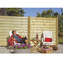 Garten mit Holzzaun und entspannter Person im Liegestuhl