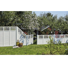 Gartenansicht mit Holzzaun und geöffnetem Gartentor vor einem Haus.