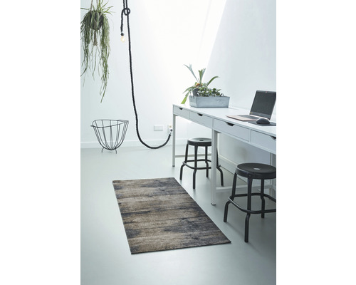 Einrichtungsbeispiel mit Teppich, Schreibtisch und Dekoration in einem hellen Raum.