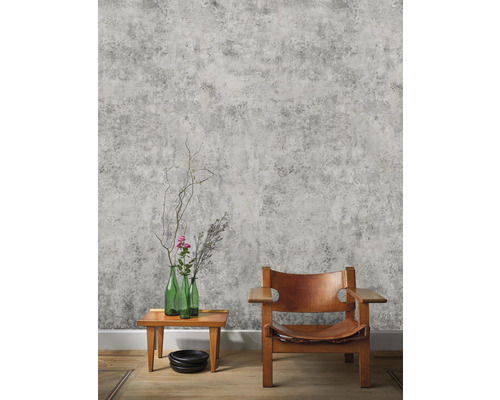 Zimmer mit grauer Betonoptik Tapete, Holztisch, Glasvasen und Holzstuhl