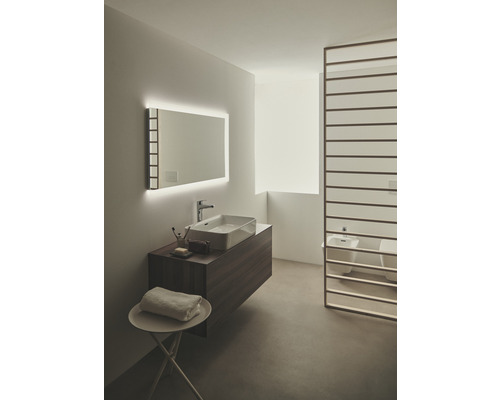 Helles Badezimmer mit Waschtisch, Spiegel mit Beleuchtung und Raumteiler