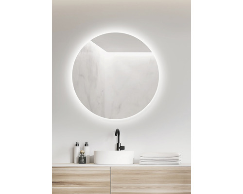 Badezimmer mit rundem Spiegel, Waschbecken und Waschtisch