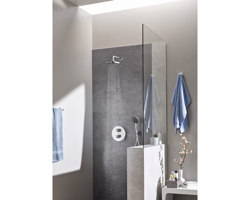 Duschbereich mit Kopfbrause, Handbrause und grauer Fliesenwand