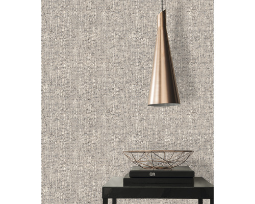 Nahaufnahme einer strukturierten Tapete mit einer Lampe und dekorativen Gegenständen auf einem Tisch