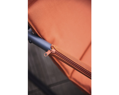 Detailaufnahme eines orangefarbenen Reißverschlusses an einem Möbelstück