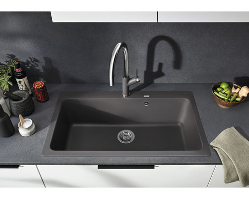 Dunkelgraues Spülbecken mit Armatur in einer Küchenszene