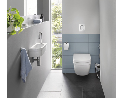 Badezimmer mit wandhängendem WC, Waschbecken und Fliesen