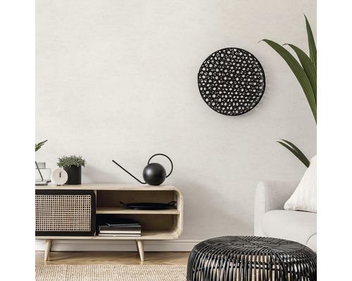 Wohnzimmer mit Lowboard, runder Wanddekoration und Korbtisch