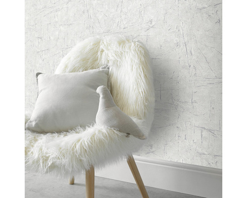 Gemusterte Tapete mit Sessel, Kissen und Dekofigur