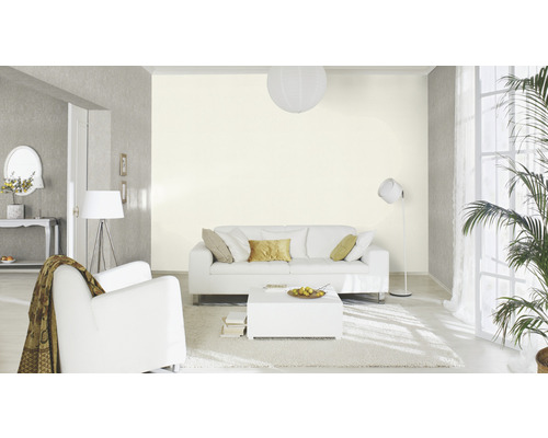 Wohnzimmer mit Sofa, Sessel, Couchtisch, Stehlampe und Zimmerpflanze