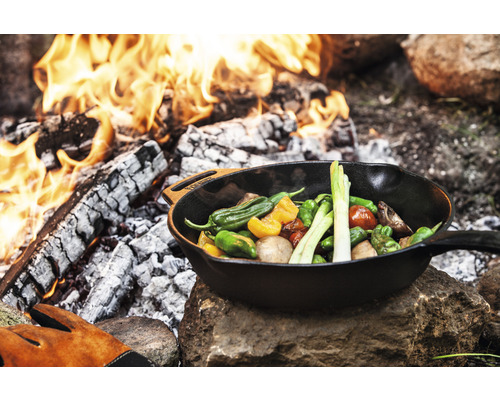 Gemüse in einer Bratpfanne über offenem Feuer zubereitet