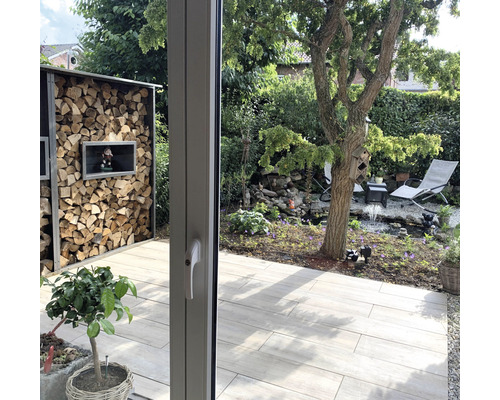 Gartenansicht mit Holzregal, Teich und Gartenmöbeln