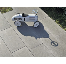 Helle Terrassenplatten aus Stein mit Spielzeugauto