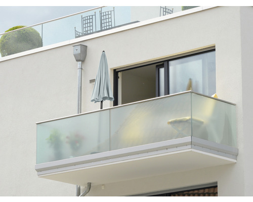 Außenansicht eines Balkons mit Glasgeländer und Sonnenschirm