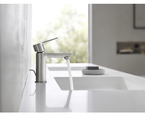 Wasserhahn aus Metall mit fließendem Wasser in einem hellen Badezimmer