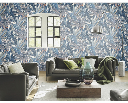 Wohnzimmer mit blau gemusterter Blättertapete, Sofa und Holztisch