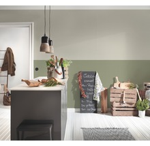 Helle Küche mit Kücheninsel, Kreidetafel und Holzkisten zur Dekoration.