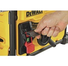 Ein Mensch bedient den Ein- und Ausschalter einer DeWalt Tischkreissäge.