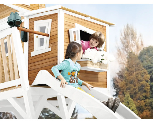 Kinder spielen auf einem Holzspielhaus mit Rutsche und Fenster
