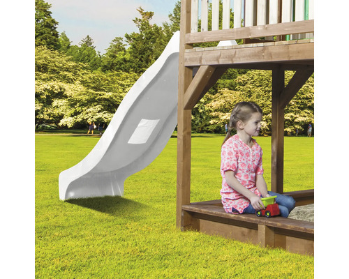 Kind auf einem Spielplatz mit Rutsche und Sandkasten