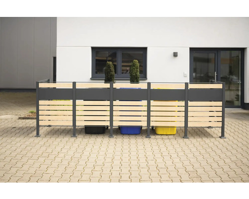 Mülltonnenbox mit Holzverkleidung vor einem Gebäude