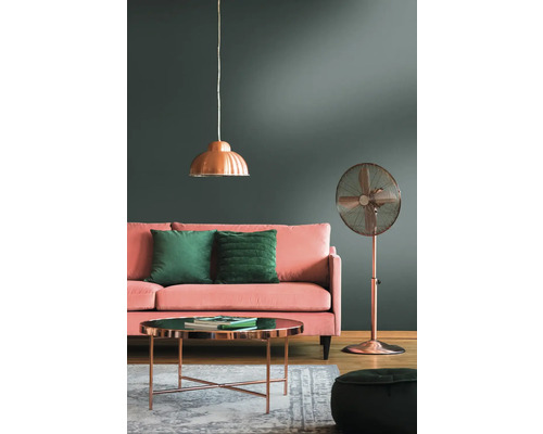 Wohnzimmer mit Sofa, Kissen, Tisch, Stehventilator und Pendelleuchte