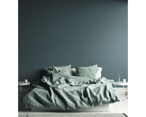 Schlafzimmer mit Bett, Kissen und Beistelltischen